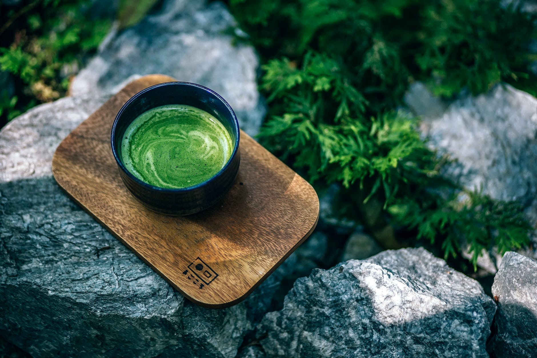 photo of matcha drink on a wooden tray