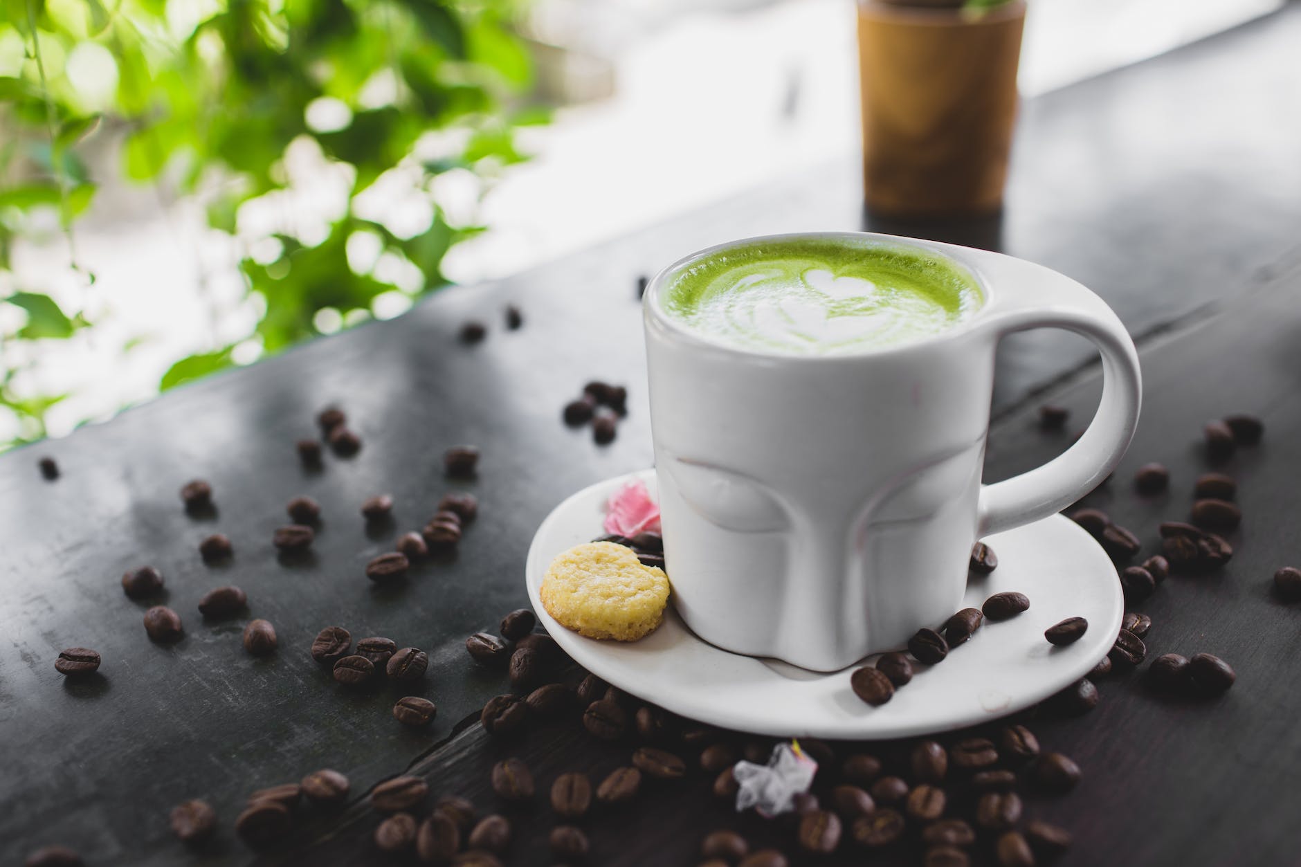 close up photo of matcha latte on a ceramic cup