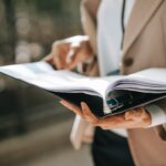 anonymous businesswoman with papers in folder