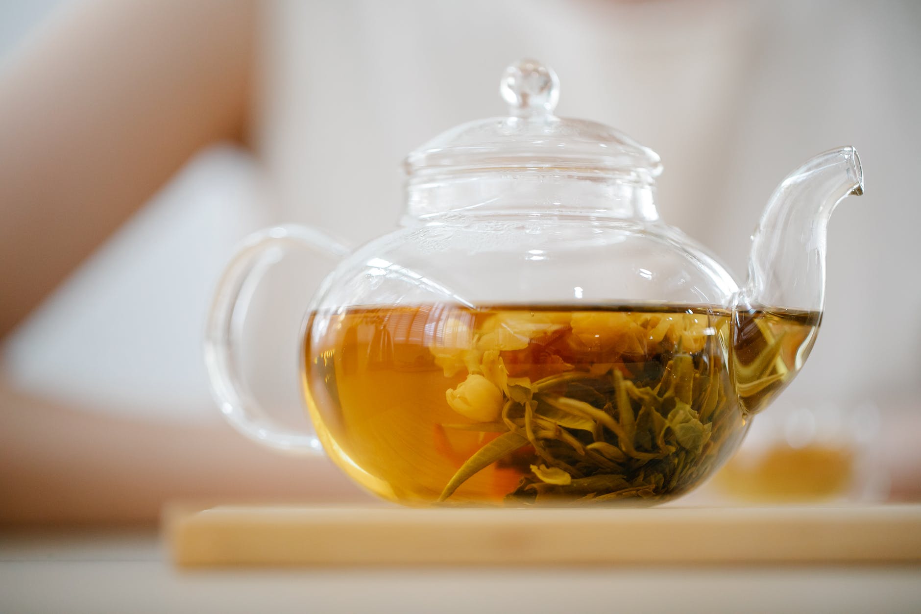 close up photo of clear glass teapot with herbal tea