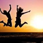 silhouette photography of jump shot of two persons