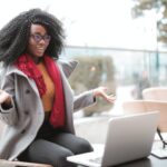 cheerful surprised woman sitting with laptop