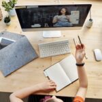 top view photo of girl watching through imac