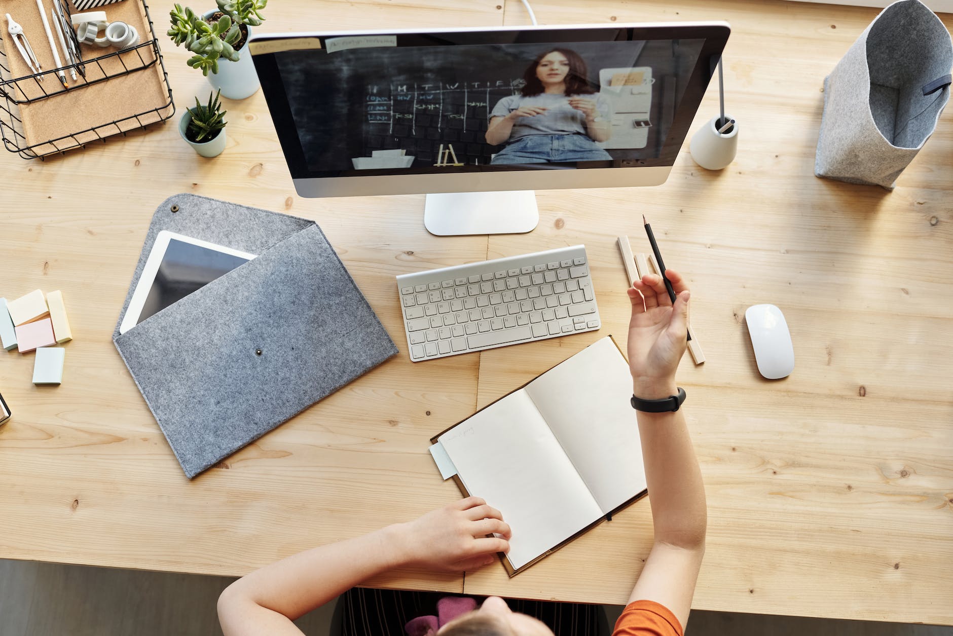 top view photo of girl watching through imac