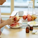 crop asian woman peeling apples at table with various medicines