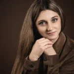 crop woman with long silky hair on brown background